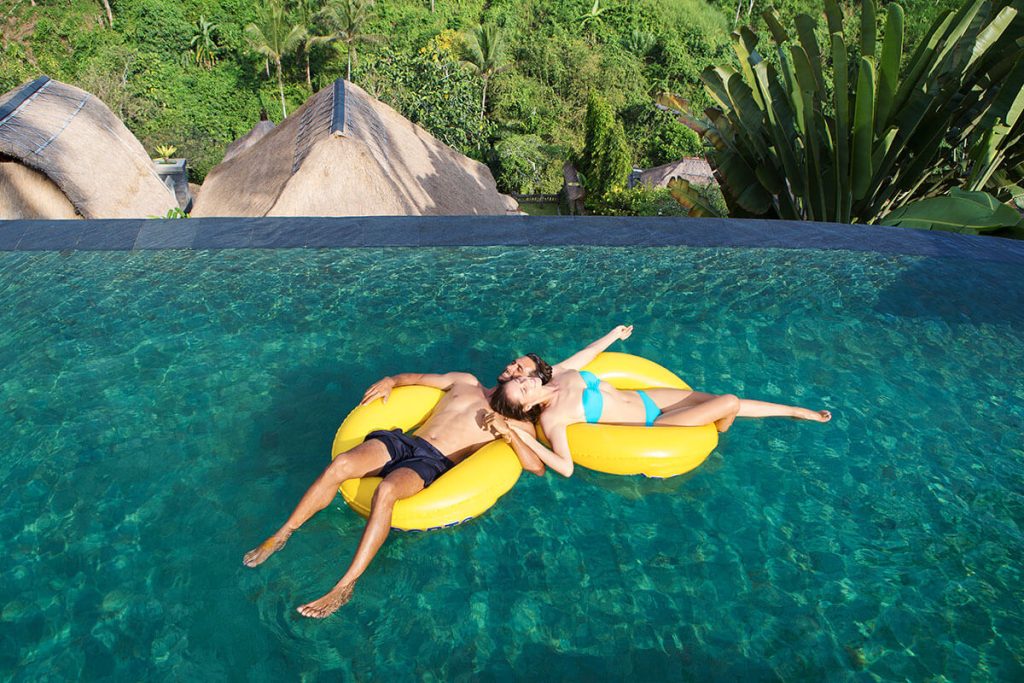 Couple relax in Viceroy Bali main pool