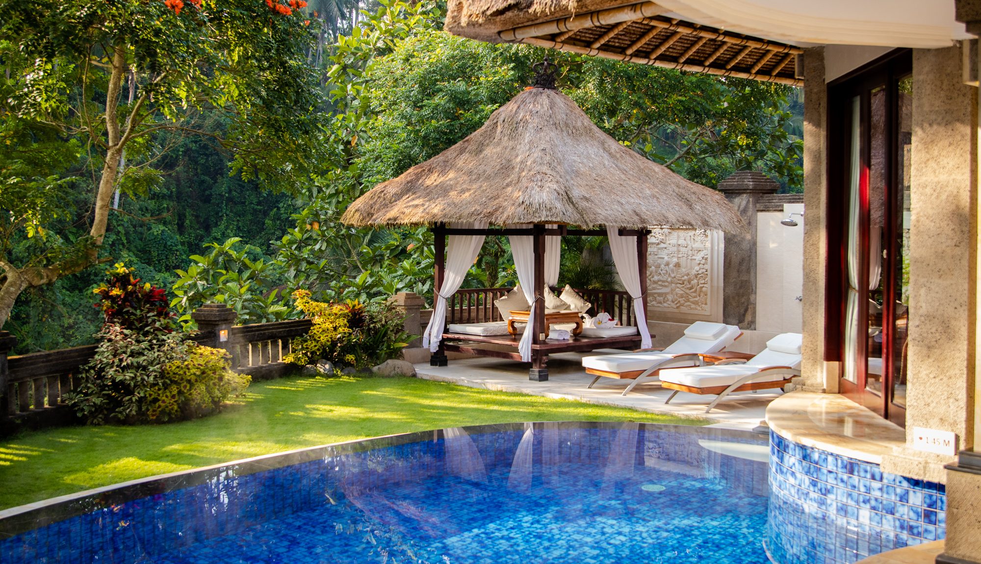 The gazebo, pool chairs and pool in one of the honeymoon villas at Viceroy Bali