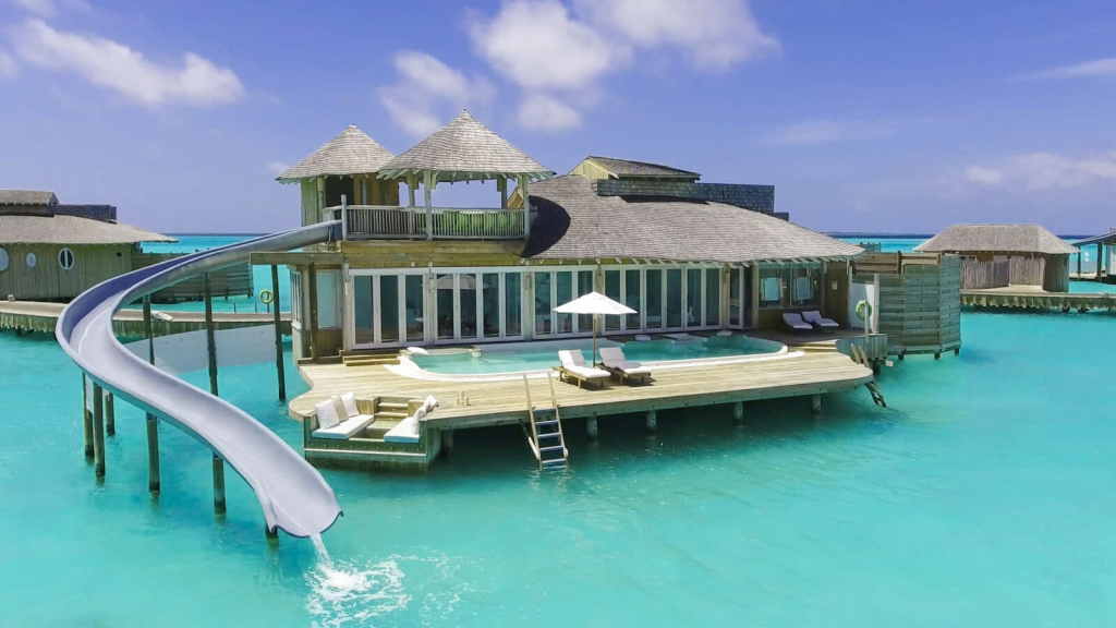 A Maldives overwater villa with slide