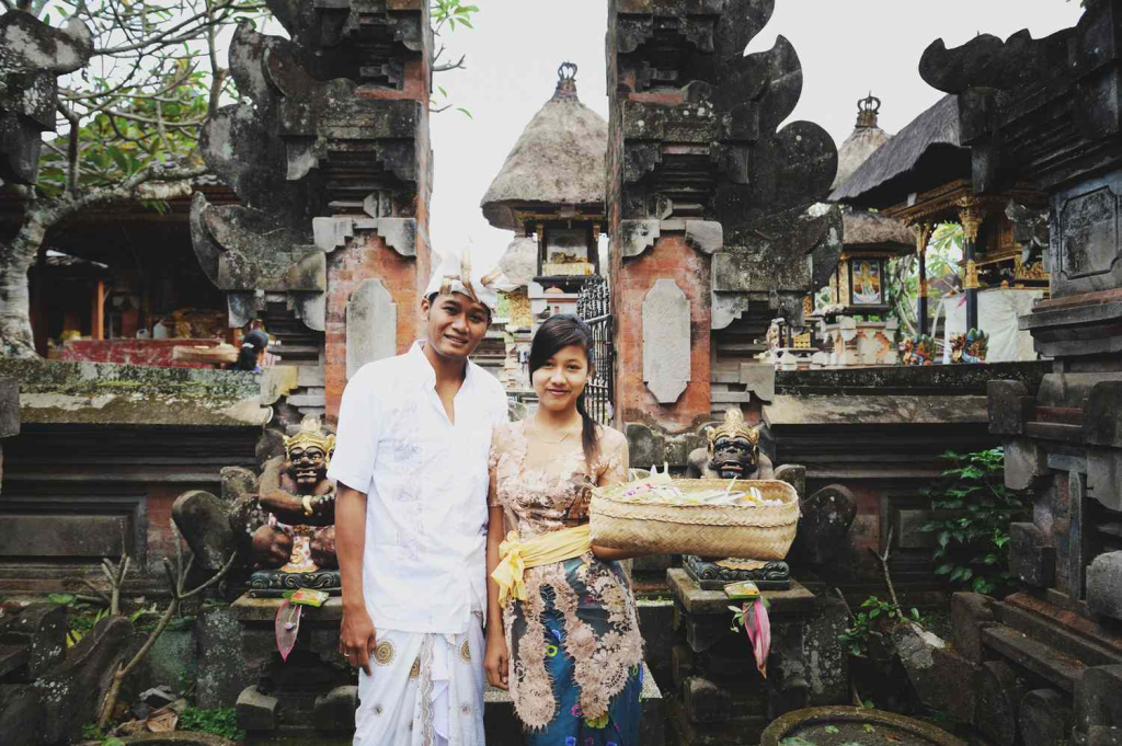 A Balinese couple with offerings for Galungan and Kuningan