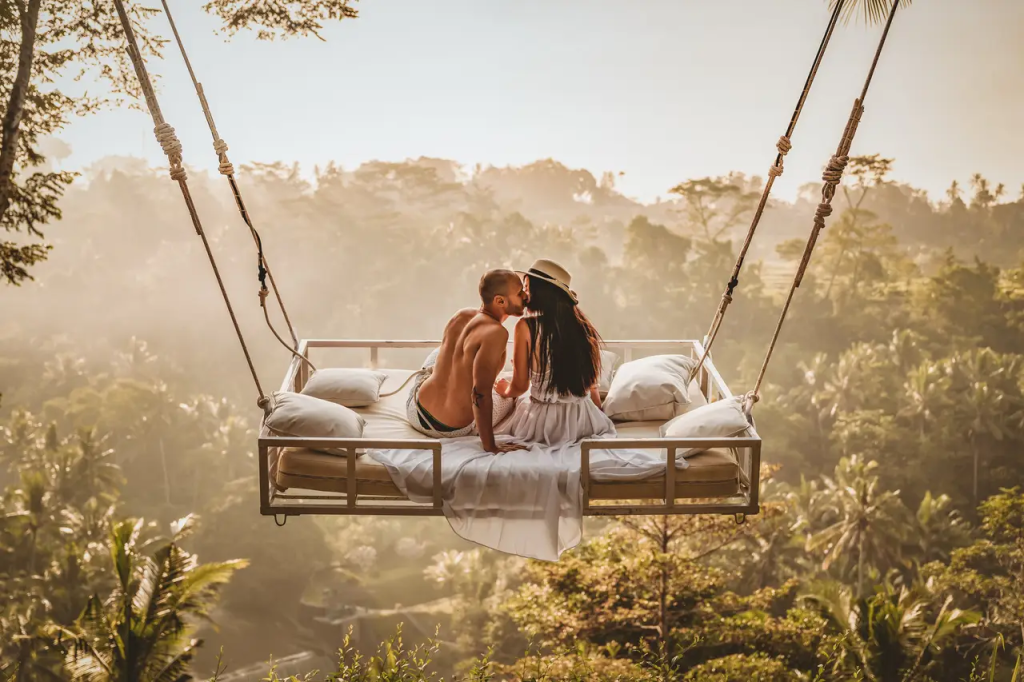 A couple on their honeymoon enjoying a Bali swing