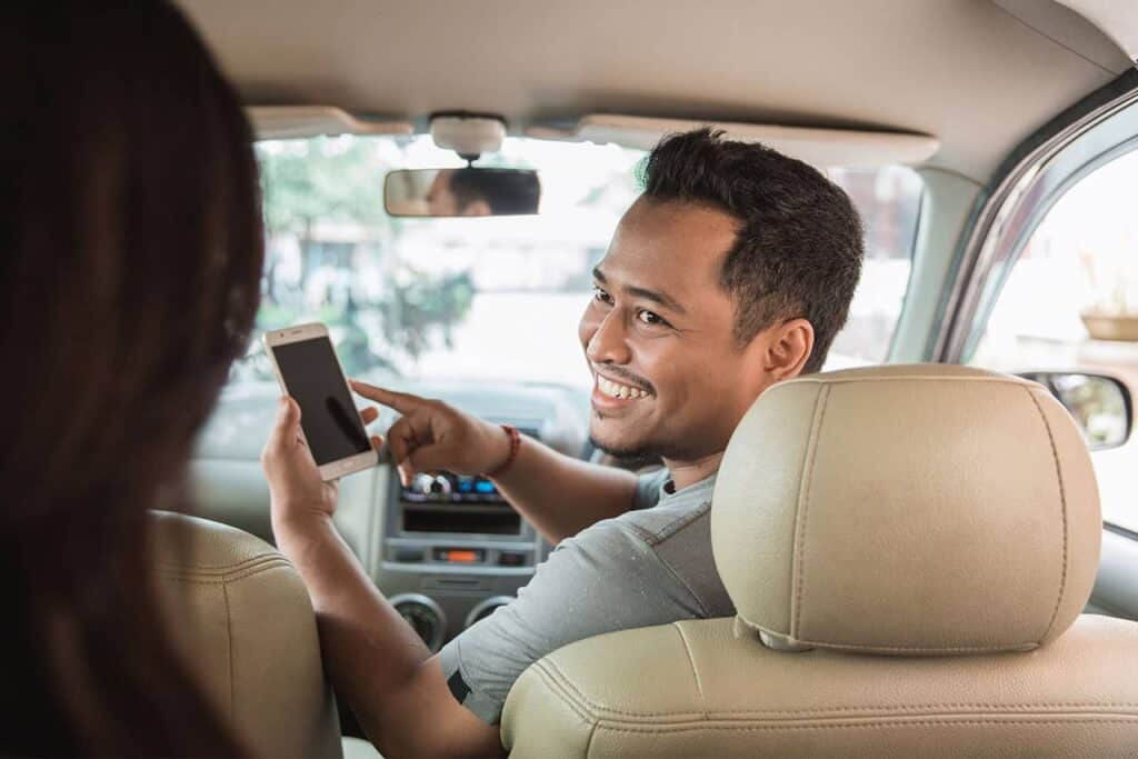 A taxi driver talking to a customer