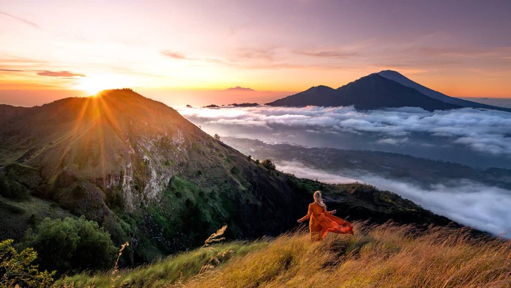 A woman standing on Mount Batur at Sunrise