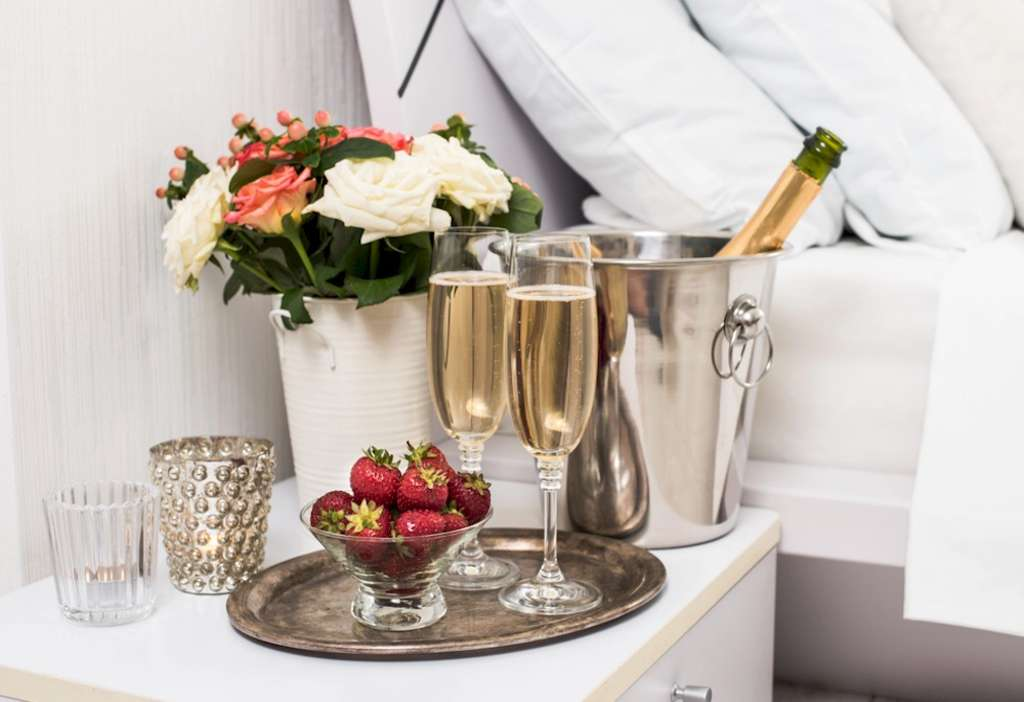 Gourmet room service of champagne, strawberries and roses