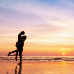 A couple hugging on a Bali beach on their honeymoon