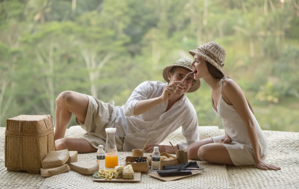 A couple sharing a picnic on their honeymoon