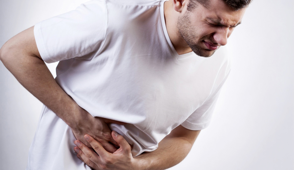 A man holding his stomach experiencing Bali belly