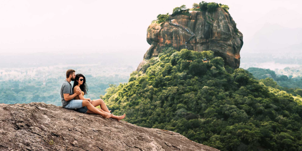 A couple sitting on a mountain in Sri Lanka