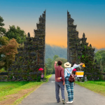 Two tourists standing in front of a Bali attraction