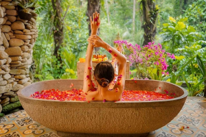A woman enjoying a luxurious flower bath in a luxury hotel