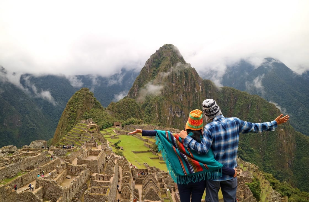 A couple standing on the top of Machu Picchu, Peru