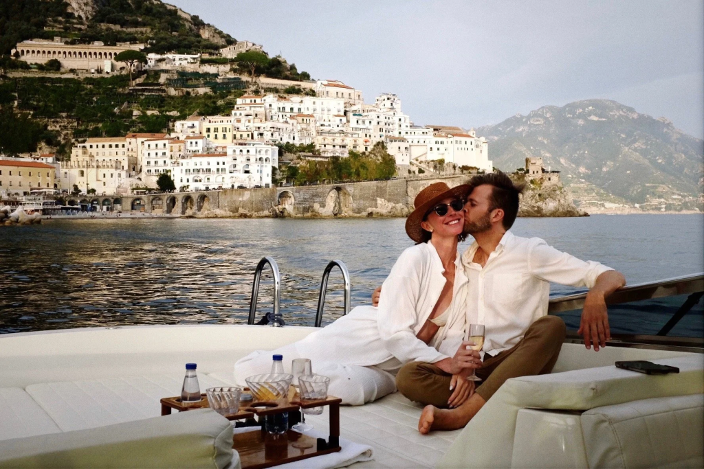 A couple on a luxury boat in the Amalfi Coast in Italy