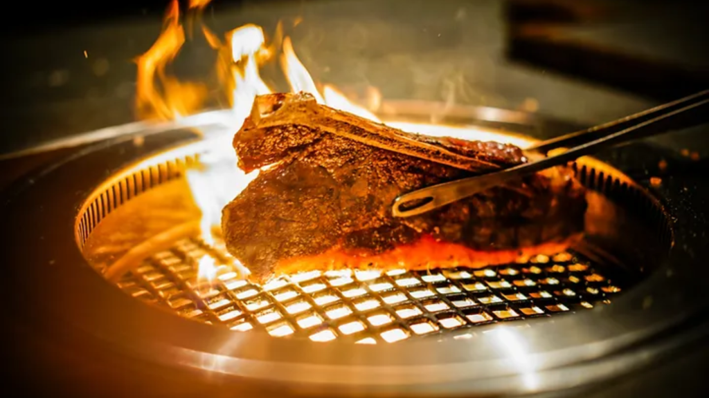 A t bone steak on a grill from a steakhouse in Bali