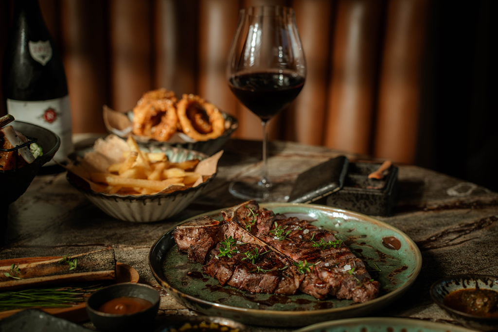A steak and glass of red wine from Bali's Saltlick